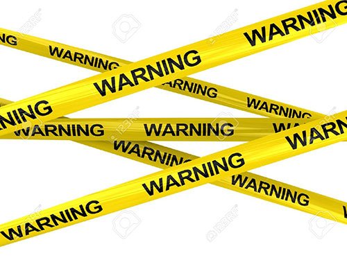 Multiple strips of yellow caution tape crisscross over a white background, each printed with the word 'WARNING' in black.