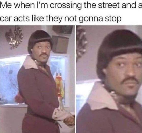 A meme with the caption "Me when I'm crossing the street and a car acts like they not gonna stop," featuring two side-by-side photos of a man in a brown jacket and beanie with a suspicious, side-eye expression.
