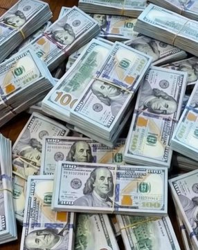 A large pile of US hundred-dollar bills stacked in bundles.
