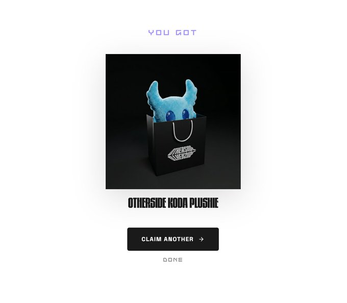 The image features a small blue stuffed animal, likely a Koda, placed inside a black shopping bag. The bag is sitting on top of a white surface, possibly a table or countertop. In the background, there are two words written in purple text that read "you got" and "claim another".