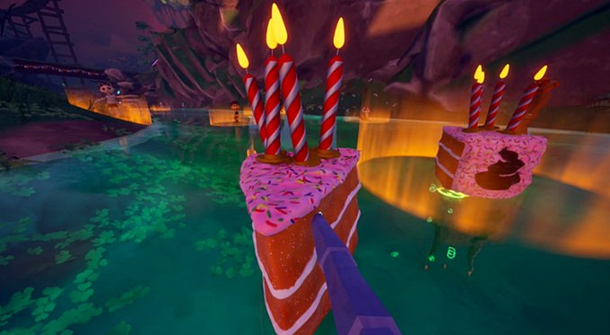 A video game scene featuring two pink-frosted cake slices with lit birthday candles floating in green water, with a purple fin visible beneath the water's surface.