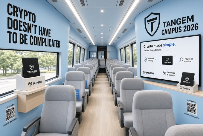 Interior of a Tangem Campus 2026 branded vehicle or train car featuring the slogan 'CRYPTO DOESN'T HAVE TO BE COMPLICATED' and 'Crypto made simple' messaging, with Tangem hardware wallet devices displayed on shelves and QR codes for more information.