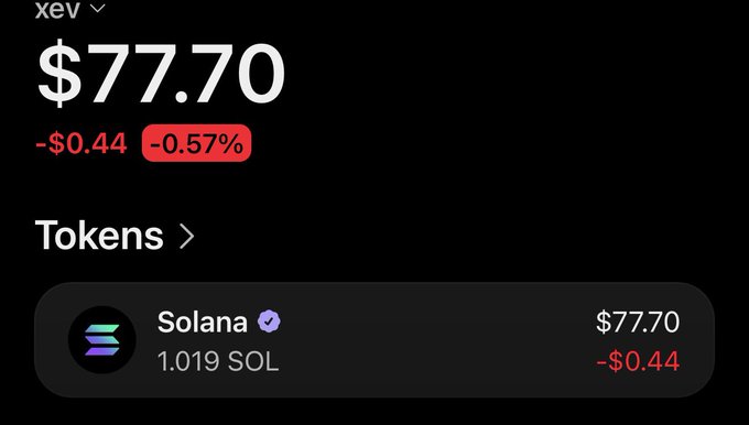 The image shows a crypto wallet displaying a balance of 1.019 SOL (Solana) valued at $77.70, down $0.44 (-0.57%). It appears to be shared in a reply to a giveaway post requesting users to comment with their SOL wallet address, likely as proof of holding SOL to qualify for the giveaway.