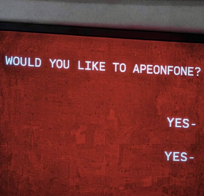 A red retro computer screen shows the text 'WOULD YOU LIKE TO APEONFONE?' with 'YES-' options below.