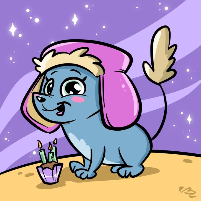 Cartoon illustration of a happy blue dog with large ears wearing a pink hood, sitting next to a small birthday cupcake with two lit candles against a purple starry background.