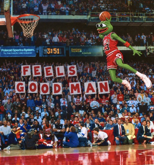 The green Muppet character 'the Frog' wearing a red Chicago Bulls #23 jersey, mid-air while going for a slam dunk, with fans in the background spelling out 'FEELS GOOD MAN' on cards.