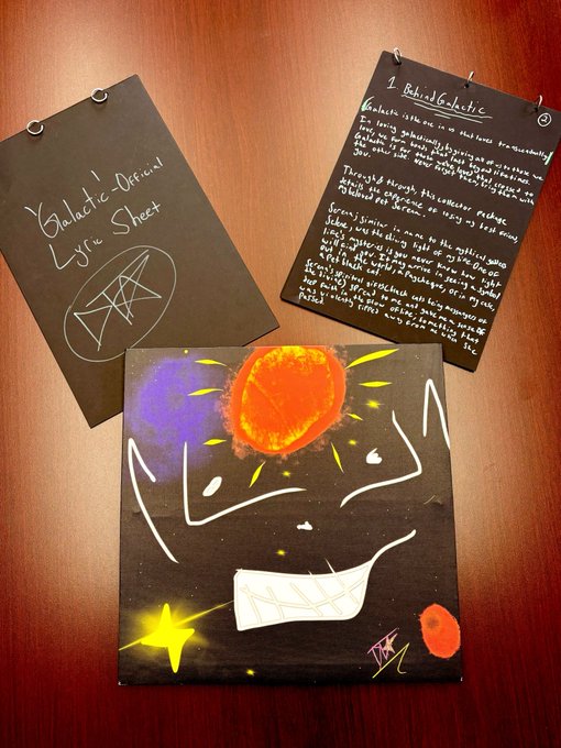 A handmade gift from artist @DivineTouchETH featuring a colorful cosmic painting with a vibrant orange planet and yellow stars, accompanied by handwritten notes including a "Galactic Life Sheet" with a geometric symbol and a page titled "1 Baby's Galactic" containing a heartfelt message.