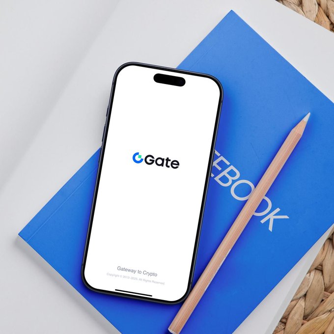 A smartphone displaying the Gate.io logo and "Gateway to Crypto" slogan rests atop a blue notebook labeled "NOTEBOOK," accompanied by a wooden pencil on a white surface with a woven mat nearby, visually reinforcing the post's message of consolidating diverse trading activities into one unified platform where "Every Trade" is accessible through a single, streamlined gateway.