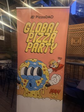 An orange vertical banner advertises a 'Global Pizza Party' by PizzaDAO dated May 22, featuring a cartoon pizza slice character with a mustache.
