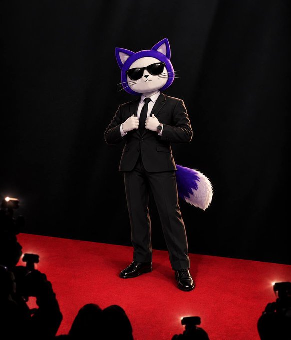 A figure wearing a black business suit and a purple cat head mask with sunglasses poses on a red carpet while photographers' flashes go off in the foreground.