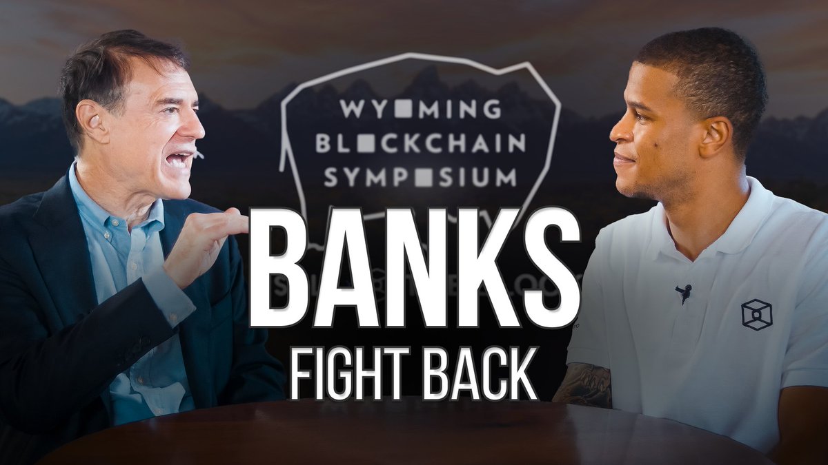 A YouTube thumbnail displays two men facing each other in profile, with the text 'BANKS FIGHT BACK' and 'WYOMING BLOCKCHAIN SYMPOSIUM' overlaid in the center.