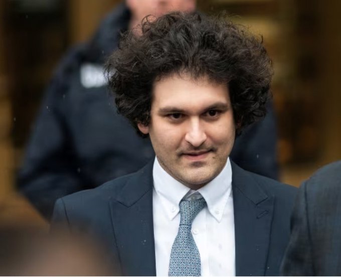 Sam Bankman-Fried, the founder of the now-defunct FTX cryptocurrency exchange, is shown in a suit with a slight smirk. His image relates to the post as he is the central figure behind FTX's collapse, which exposed the lack of transparency and backing behind tokenized assets the platform sold to investors.