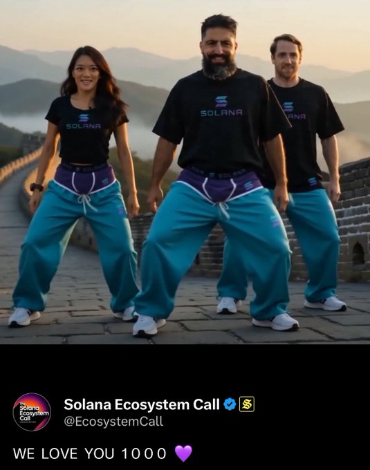Three people wear matching "SOLANA" t-shirts and baggy turquoise pants while striking a playful pose on what appears to be the Great Wall of China, with the caption "Solana Ecosystem Call @EcosystemCall - WE LOVE YOU 1000💜" displayed below. The image humorously ties to the post's acknowledgment that the scene is AI-generated, playfully depicting the Solana team "visiting the mountains" in their branded attire.