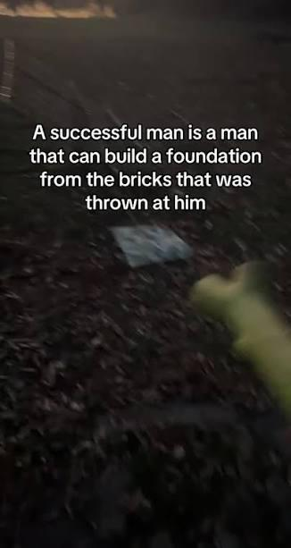 A motivational image with text reading 'A successful man is a man that can build a foundation from the bricks that was thrown at him' overlaid on a dark background of dirt and debris.