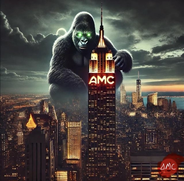 The image features a large gorilla sitting atop a skyscraper, with the words "AMC" written above its head. The gorilla appears to be holding an "AMC" sign or banner, which adds a sense of humor and playfulness to the scene. The background shows a city skyline at night, emphasizing the contrast between the wild gorilla and the urban environment.