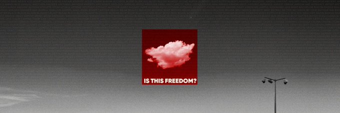 A red billboard against a gray sky displays an image of a cloud with the text "IS THIS FREEDOM?" in white letters.