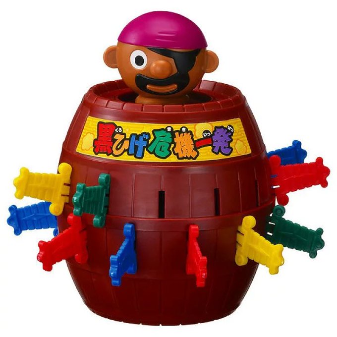 A Japanese pirate-themed barrel toy (黒ひげ危機一発 / 'Blackbeard's Barrel') featuring a pirate figure popping out of a red barrel with colorful plastic swords stuck into its sides.