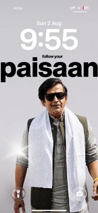 The image shows a phone lock screen at 9:55 AM on Sun 2 Aug, featuring a man wearing sunglasses and a white scarf over a gray outfit, with the bold text "follow your paisaan." This pairs with the post about money following his brother, tying into the "follow your paisaan" slogan as a nod to a follower of money/wealth.