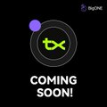 A promotional graphic featuring a purple "$TX" coin icon and the text "COMING SOON!" beneath it, with "BigONE" branding in the top corner, announcing the upcoming listing of the TX token on the BigONE exchange.
