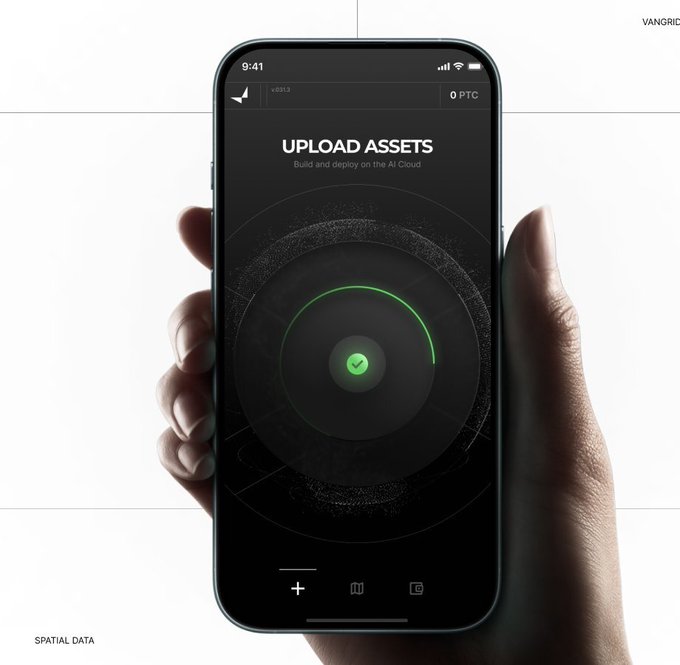 A hand holds a smartphone displaying an 'UPLOAD ASSETS' interface with a green checkmark and loading circle, branded with Vangrid and Spatial Data.