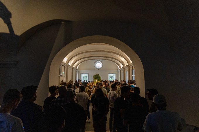 A crowd gathers beneath an illuminated vaulted archway in Lisbon, with a small green tree as the focal point in the distance.

The image captures a moment from an ETHGlobal Lisbon event, fitting the guide's focus on where attendees might gather during off hours in the city.