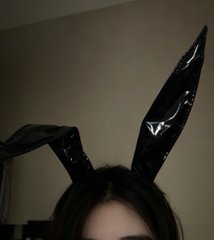 A person with dark hair wears tall, glossy black bunny ears, photographed in dim lighting with a plain wall behind them. The caption plays on the "humanity loses" trope from the movie *Don't Look Up*, subverting the apocalyptic imagery with a soft, playful bunny landing instead—pairing the absurd seriousness of the statement with the silly, cute costume.