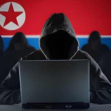 A silhouette of a hooded figure working on a laptop with the North Korean flag in the background and other hooded figures behind them.