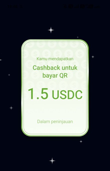 A mobile app notification on a dark background displaying "Kamu mendapatkan Cashback untuk bayar QR 1.5 USDC" with a status of "Dalam peninjauan".