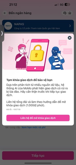 A Vietnamese mobile banking app screen shows a 'NAPAS' security warning advising the user about suspicious transactions, with instructions to call 19007118 to unlock the transaction lock.
