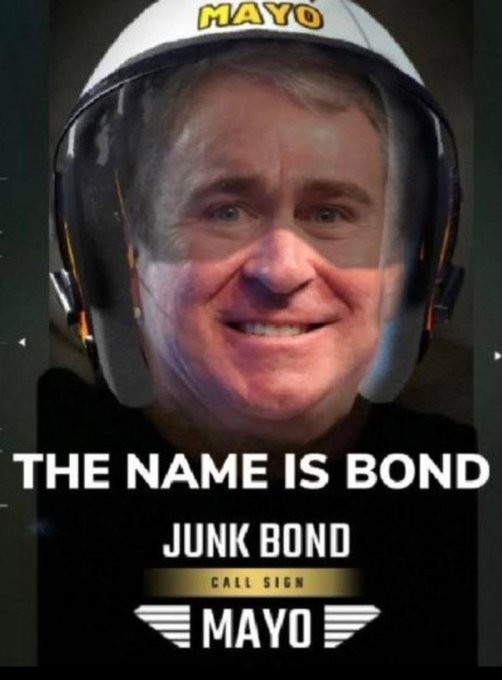 A parody image shows a man wearing a white helmet labeled "MAYO," styled like a movie poster with the text "THE NAME IS BOND," "JUNK BOND," "CALL SIGN MAYO," and pilot wings.