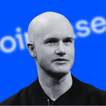 A black and white portrait of a bald man in a dark jacket against a blue background with partial text visible.
