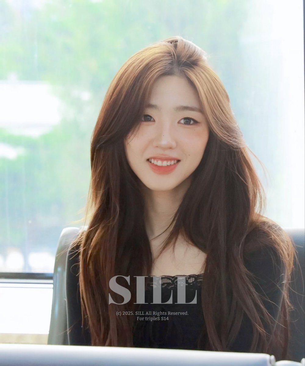 A portrait of a smiling young woman with long, wavy brown hair with blonde highlights, wearing a black lace top. The image has a 'SIII' watermark and copyright text reading '(c) 2025. SIII. All Rights Reserved. For tripleS S14'.