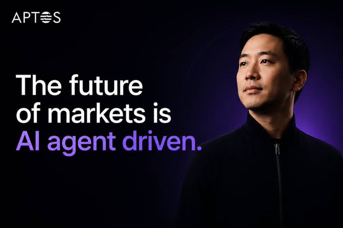 The image features a man wearing a black jacket standing against a purple background with the text "The Future of Markets is Agent Driven" written above him, and "Aptos Labs" below his head. The phrase "Wall Street moves in seconds. Agents move in milliseconds." is also present on the image. This suggests that the future of markets will be driven by agents who can quickly respond to market changes, similar to how Wall Street operates at a fast pace.