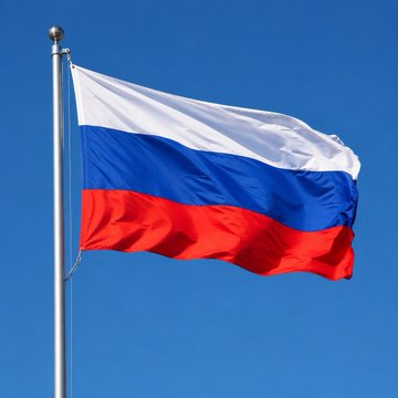 The Russian tricolor flag waves against a clear blue sky, symbolizing the nation behind a new government decree banning cryptocurrency mining and mining pool participation in the Moscow region through 2032 due to high energy consumption.