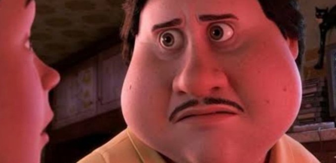 A close-up animated shot of a man with wide eyes and a concerned expression, bathed in red lighting, with another character partially visible in the foreground.