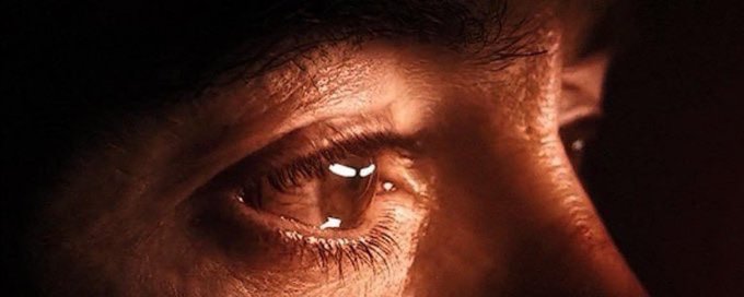 A close-up shot of a person's eye, intensely lit in dark, fiery tones, reflecting a sharp, diamond-shaped glint of light. The dramatic gaze mirrors the post's suggestion of focus and resolution, as if zeroing in on a target or moment of decision.