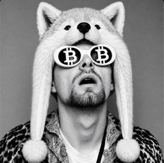 A black-and-white photo of a man wearing a white furry fox-ear hat with pom-poms and Bitcoin (B) logo sunglasses, dressed in a leopard-print shirt.