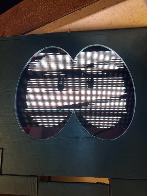 A digital traffic sign displaying an obscured or unreadable message within a double-circle border.