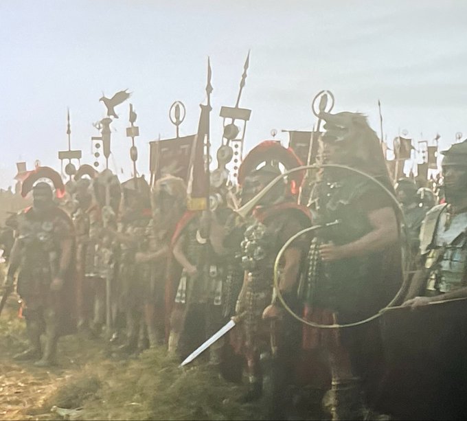 The image shows a group of people dressed in Roman armor standing together, possibly as soldiers or participants in an event related to the Matrix. The scene takes place outdoors with a grassy area where they are gathered. There are multiple flags present, which could be part of their attire or decorations for some reason. A bird is also visible in the image, flying above them.

The post that accompanies this image provides information about the current situation and events related to the Matrix. It mentions that since we've already entered the Aquarius portal, the scenario unfolds differently than before. The Matrix has been reset at 12 o'clock, and L Stellar Lumens is rising strangely differently than before. This could be a part of an event or gathering involving Roman soldiers and their interaction with the Matrix.