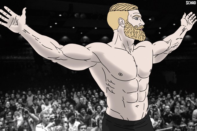 A cartoon-style illustration shows a muscular, shirtless man with blonde hair and a beard standing triumphantly with arms raised before a crowd in an arena, with the watermark 'SCHAD' in the top right corner.