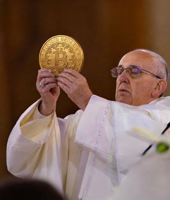 A photograph of Pope Francis in white vestments and glasses, performing a religious ritual by holding up a large golden coin featuring the Bitcoin logo.