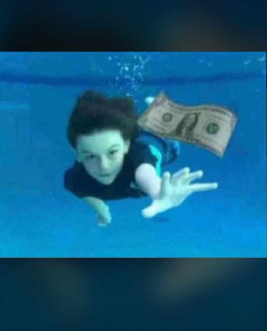 The image shows a young boy swimming underwater, reaching out toward a floating dollar bill, symbolizing the pursuit of financial success. This relates to the post's message about taking risks and staying consistent to grow in the crypto space, as capturing opportunities often requires both courage and perseverance.