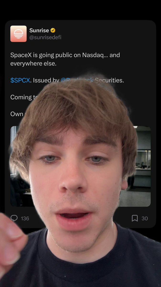 The image features a young man with brown hair wearing a black shirt, who appears to be making a funny face or gesture as he looks at his phone screen. The caption of the image reads "you can officially buy the SpaceX IPO on solana my dads been saying he’s liquidating his entire stock portfolio to buy this IPO now i can tell him to do it in 15 seconds through solana". This post seems to be promoting a product or service related to the SpaceX IPO, and the young man's reaction suggests that he is either surprised by the information or amused by the content on his phone.