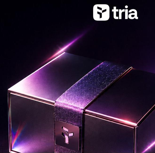 The image features a gift box with a purple ribbon around its neck, placed against a black background. The text "Happy Wednesday CT Are there still some projects quietly building?" is written above the gift box, which seems to be related to the post about the Tria project on social media.

In addition to the main image, there are two smaller images in the bottom right corner of the photo: a small logo and a small picture of a person's face. The text "@NomismaNetwork is steadily moving towards creating an AI-driven onchain finance ecosystem @useTria" can also be seen in the image.