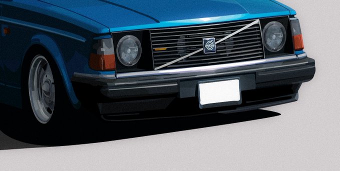The front end of a blue Volvo car showcases its signature diagonal grille with the Volvo emblem and round dual headlights.