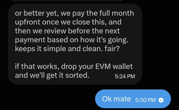 A text message conversation discussing payment terms, with the sender offering to pay a full month upfront and asking the recipient to drop their EVM wallet, followed by a reply 'Ok mate'.