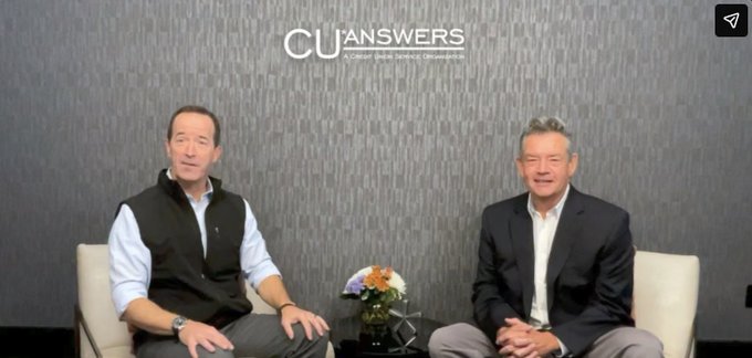 Two men seated in front of a wall displaying the 'CU Answers' logo with the tagline 'CUSTOMER. CHOICE. EXPERIENCE. INNOVATION.'