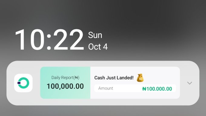 A digital clock display showing '10:22 Sun Oct 4'. A notification widget below announces 'Daily Report(N) 100,000.00' with the message 'Cash Just Landed!' and 'Amount ₦100,000.00'.