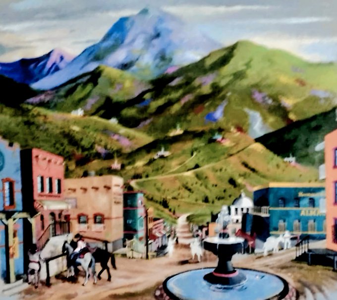 A stylized painted village scene featuring colorful buildings, a horse, and a central fountain set against vibrant green mountains under a cloudy sky.