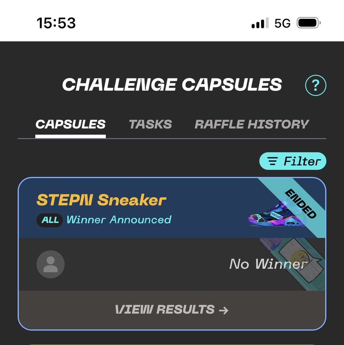 The image shows a phone screen with an app called "Challenge Capsules" displayed, which appears to be a sneaker-related challenge or competition. The app has a filter that allows users to see the results of their participation in the challenge. There is also a message on the app stating that no winner has been announced yet.